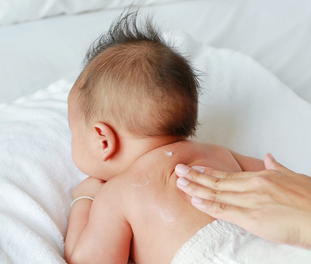 mother-are-applying-lotion-cream-baby-body-after-bath-baby-care-concept